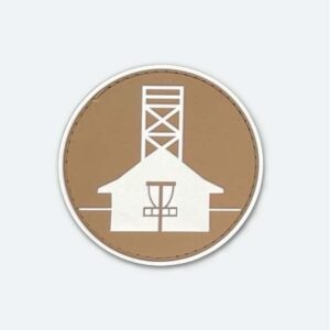 Velcro patch with white Beaches Disc Golf Course logo that glows in the dark, and set on a sand coloured background.