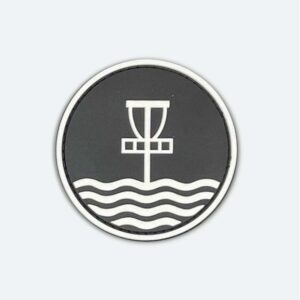 Velcro patch with white Marilyn Bell Park Disc Golf Course logo that glows in the dark, and set on a black background.