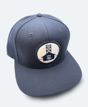 Classic dark blue 6 panel snapback hat with flat brim and blue Beaches Disc Golf Course logo patch on a white background.
