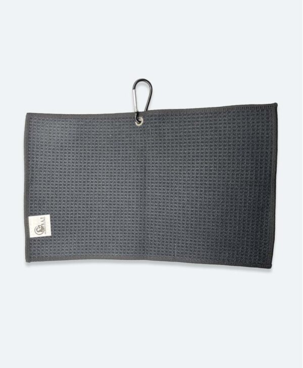 The waffle weave backside of the GOAT disc golf towel, used to clear large debris from your discs while playing disc golf.