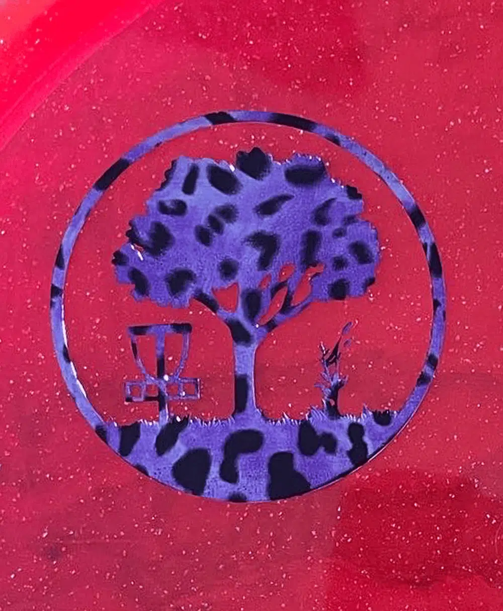 Purple Leopard Scarlett Woods Disc Golf Course quarter stamp on a red Metal Flake C-Line MD3.